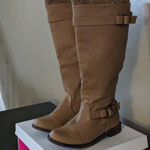 Leight beige tall boots with socks design on top.